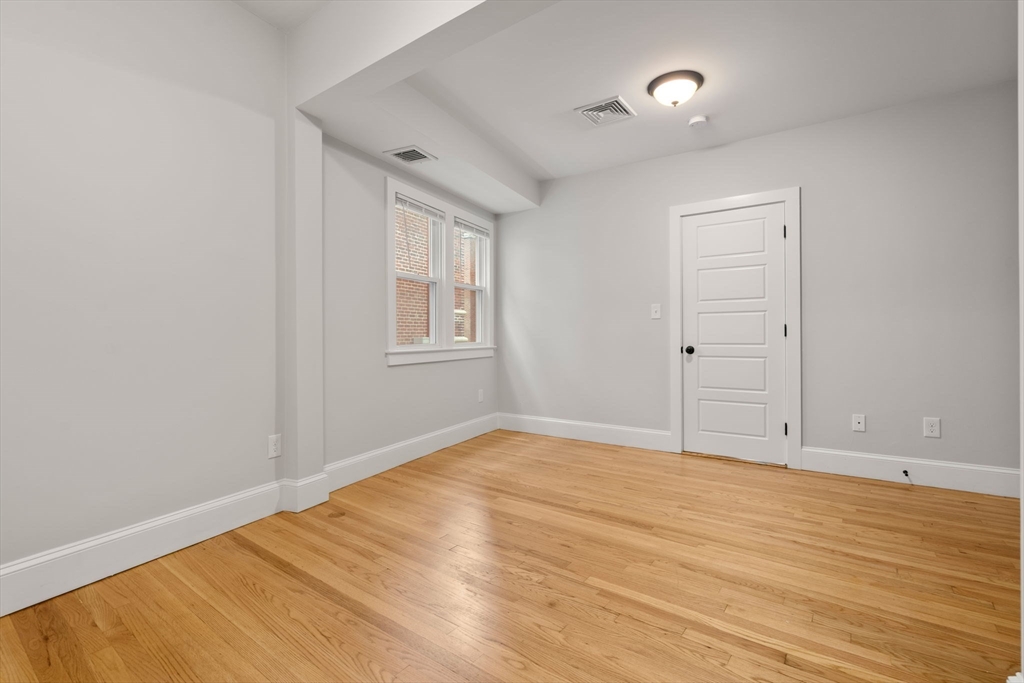 129 Sutherland Road, Unit A Boston, MA 02135 - Photo 20 of 38 wooden floor in an empty room