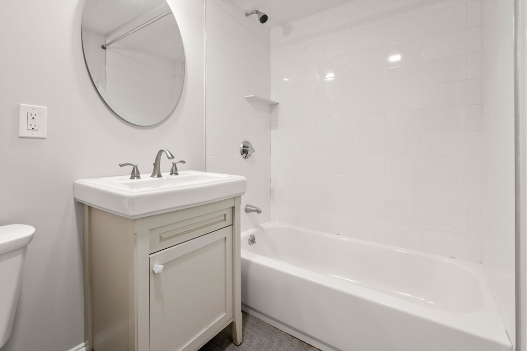 129 Sutherland Road, Unit A Boston, MA 02135 - Photo 23 of 38 a bathroom with a sink a toilet and a bathtub