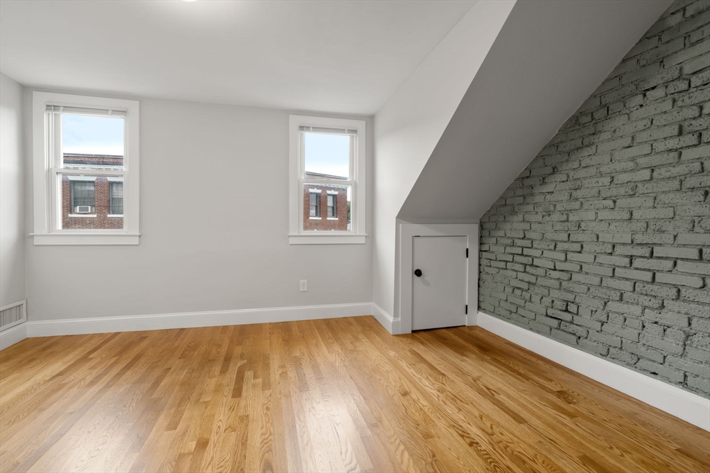 129 Sutherland Road, Unit A Boston, MA 02135 - Photo 30 of 38 a view of a big room with wooden floor and windows