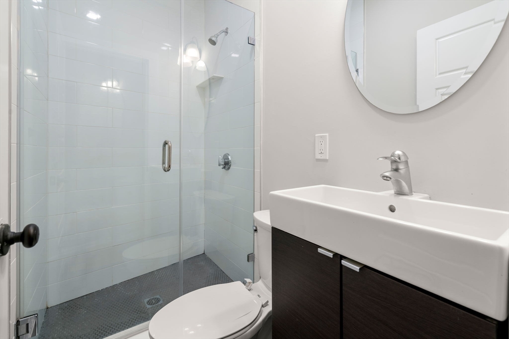 129 Sutherland Road, Unit A Boston, MA 02135 - Photo 6 of 38 a bathroom with a sink a toilet and shower