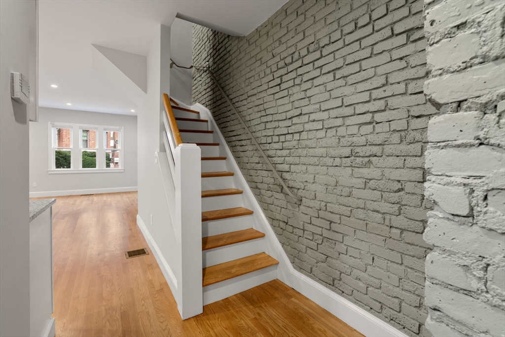 129 Sutherland Road, Unit A Boston, MA 02135 - Photo 9 of 38 a view of entryway with wooden floor