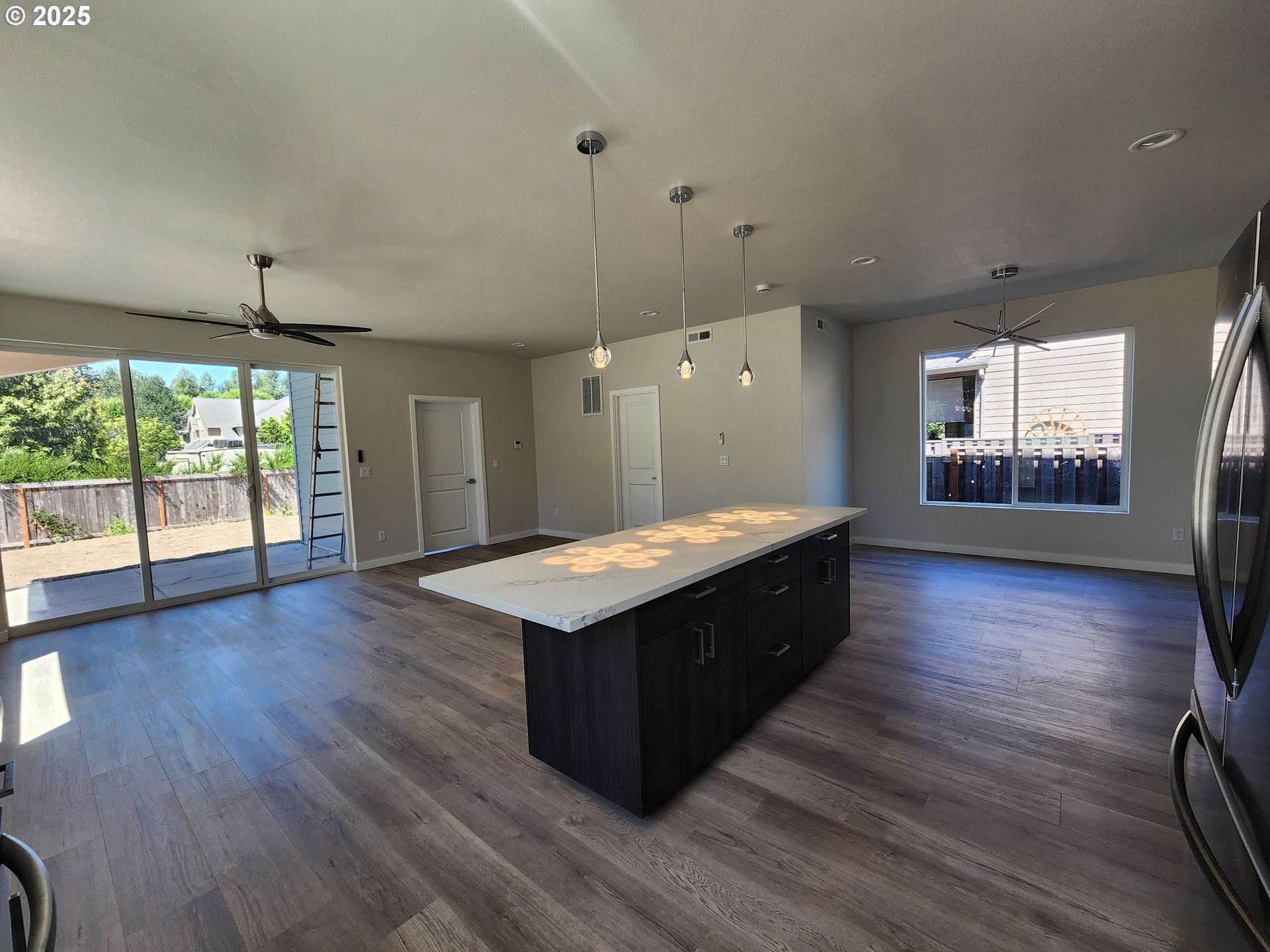 28683 Southwest Canyon Creek Road Wilsonville, OR 97070 - Photo 12 of 29 a kitchen with wooden floors and windows