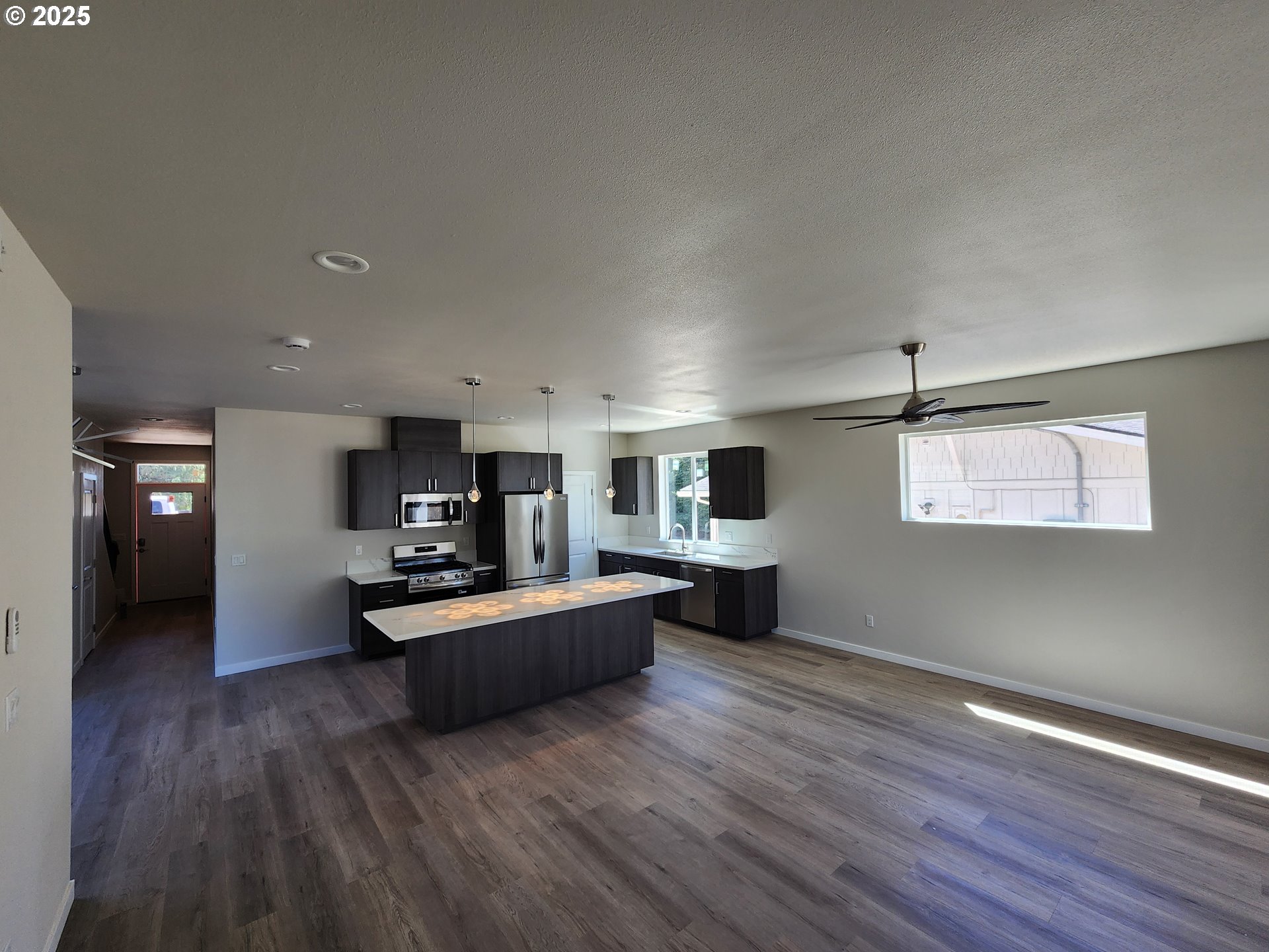 28683 Southwest Canyon Creek Road Wilsonville, OR 97070 - Photo 3 of 29 a living room with furniture and a wooden floor