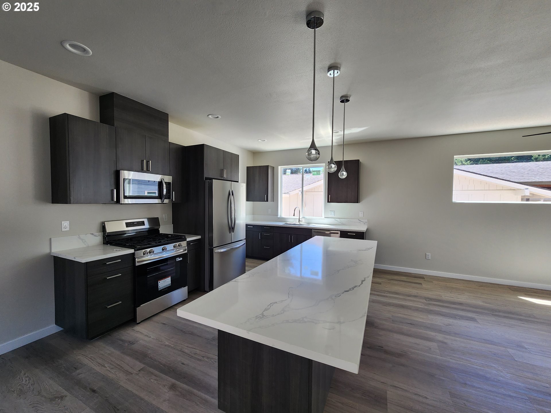 28683 Southwest Canyon Creek Road Wilsonville, OR 97070 - Photo 5 of 29 a kitchen with kitchen island a counter space a sink appliances and cabinets