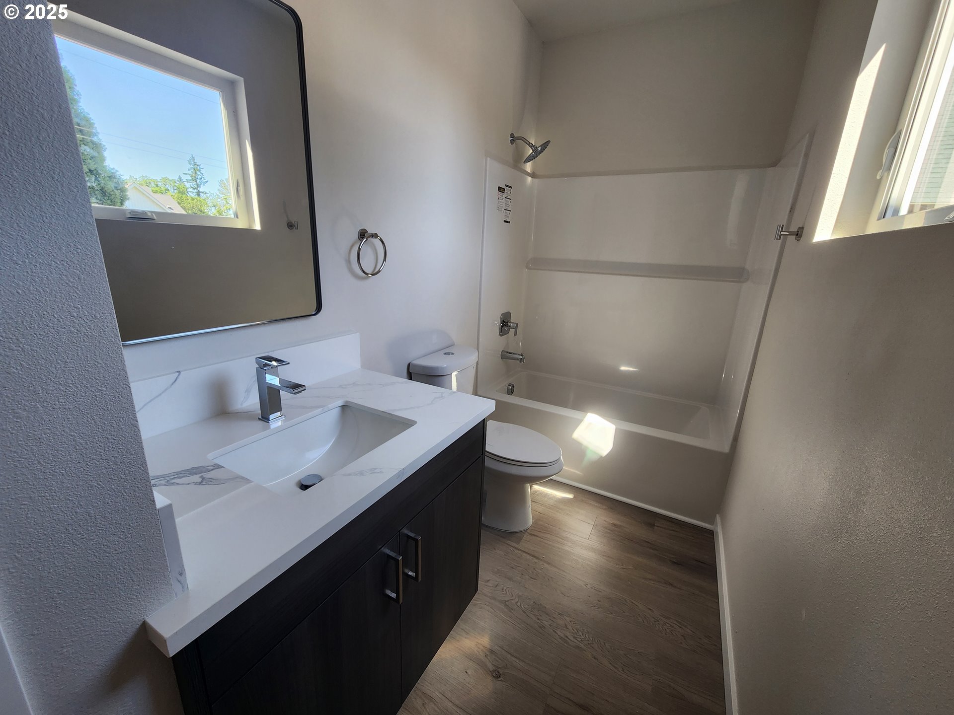 28683 Southwest Canyon Creek Road Wilsonville, OR 97070 - Photo 6 of 29 a bathroom with a sink toilet a mirror and shower
