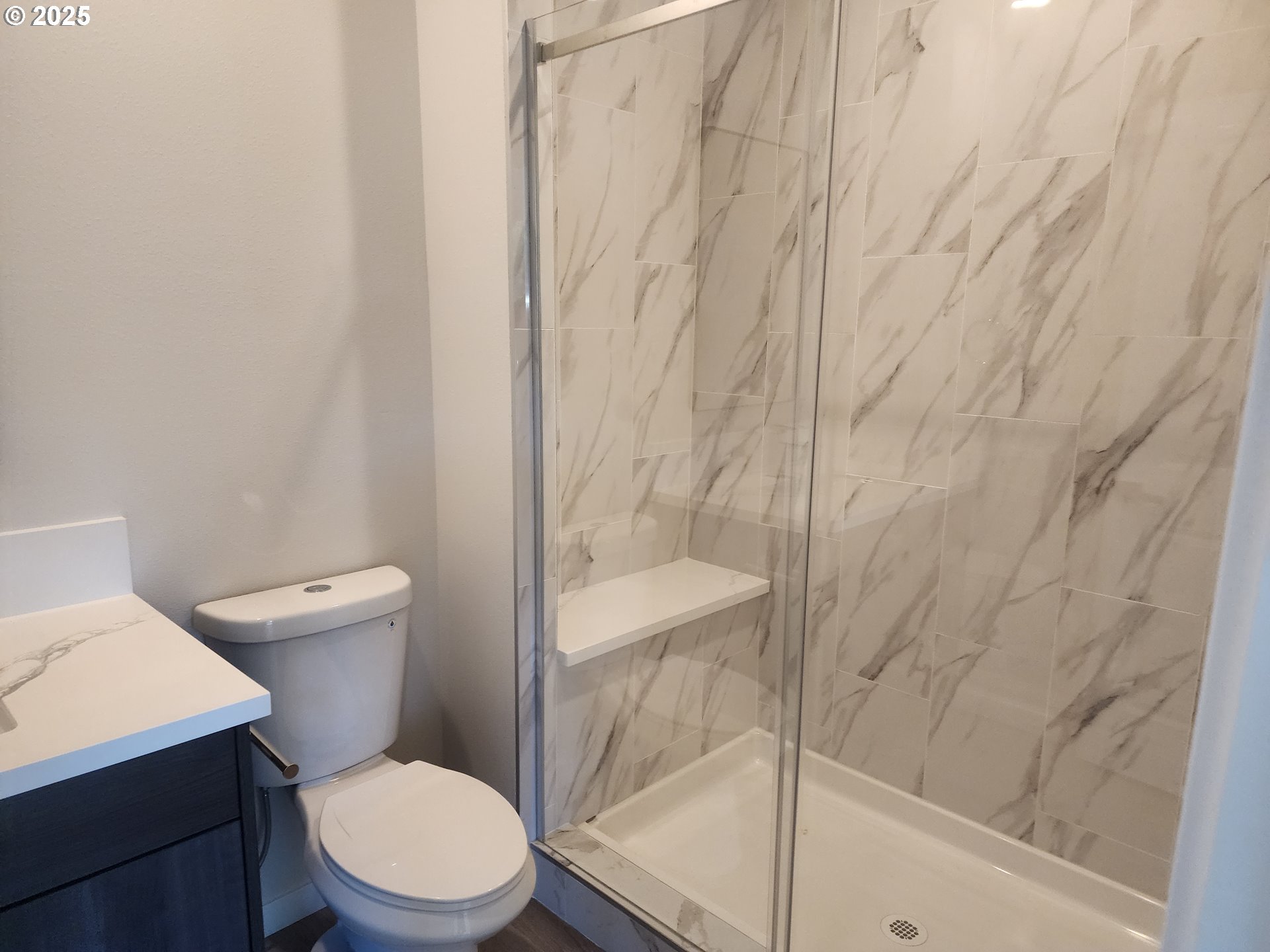 28683 Southwest Canyon Creek Road Wilsonville, OR 97070 - Photo 10 of 29 a white toilet sitting next to a shower