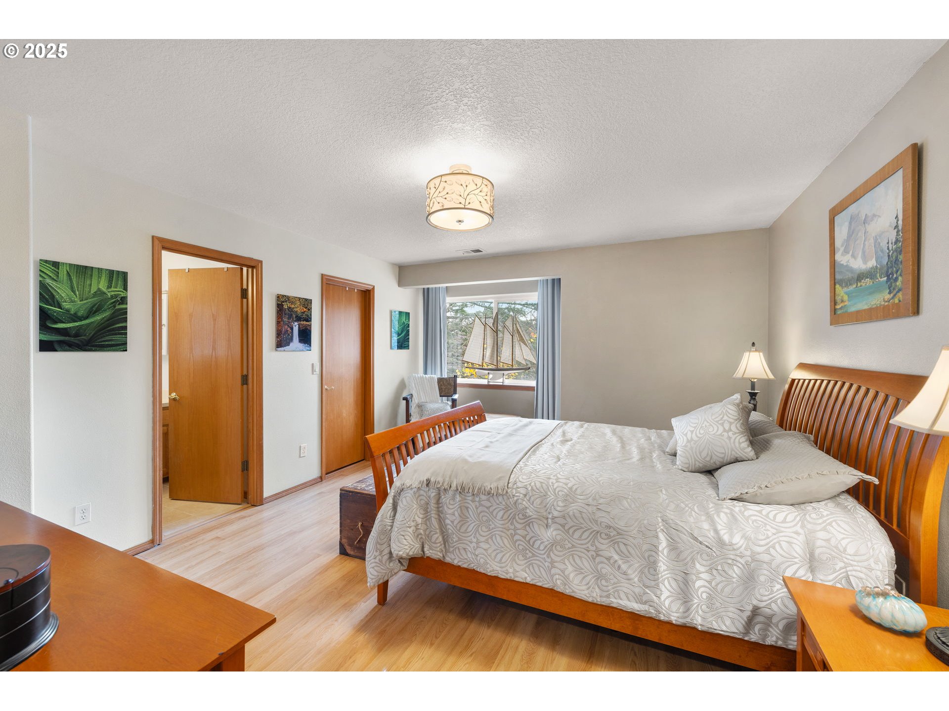 1021 Southwest 24th Street Troutdale, OR 97060 - Photo 15 of 34 a bedroom with a bed and wooden floor