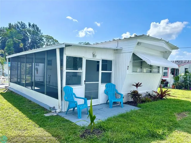 a front view of a house with a yard and porch