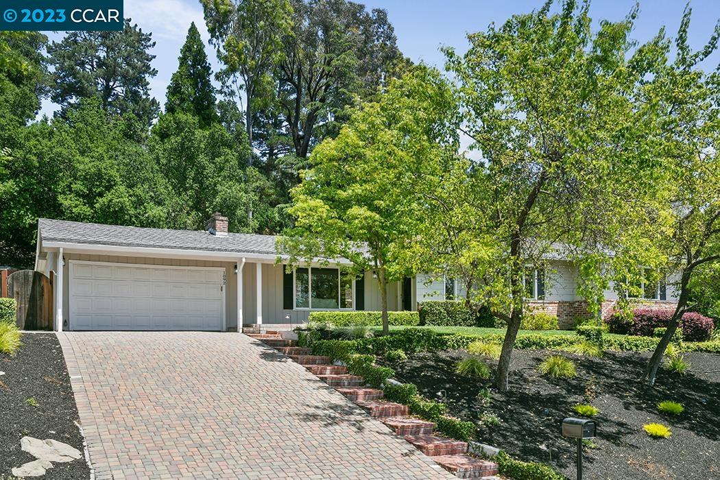 a front view of a house with a yard and a garage