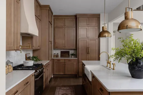 a kitchen with stainless steel appliances a sink stove and refrigerator