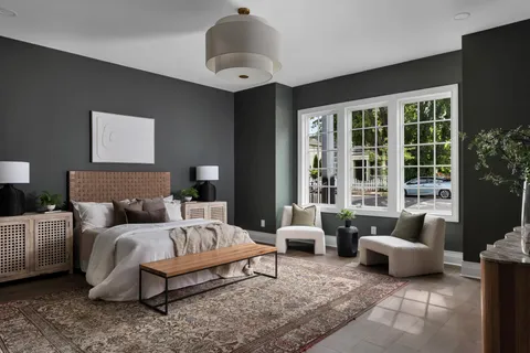 a bedroom with furniture and a large window