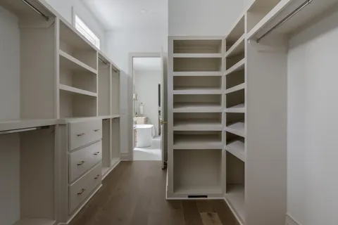 a view of walk in closet with empty racks
