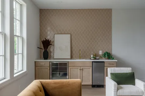 a living room with furniture and a chandelier
