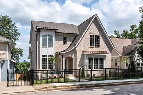a view of a white house with large windows