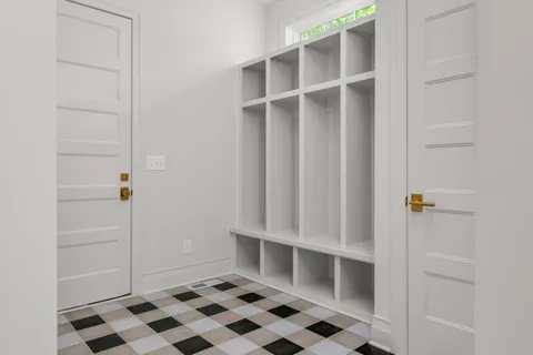 a kitchen with granite countertop white cabinets and white appliances