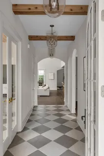 a view of a room with a chandelier and dining table
