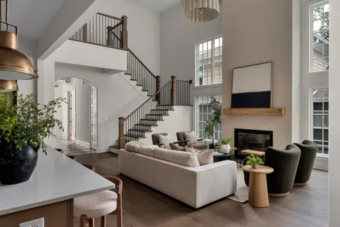 a living room with furniture a fireplace and a potted plant