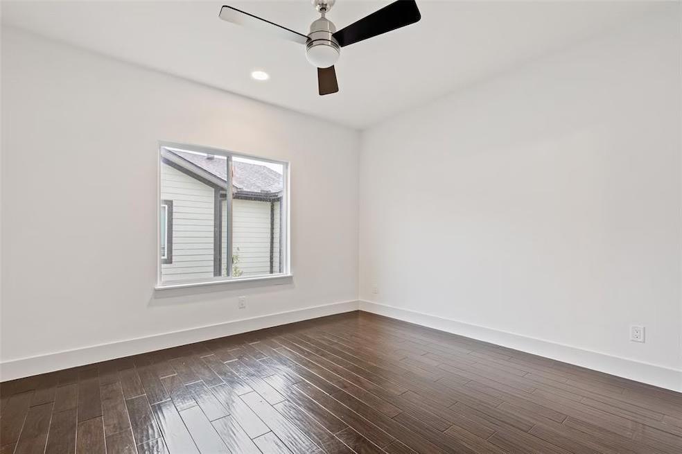 5924 Hudson Street, Unit F Dallas, TX 75206 - Photo 15 of 25 an empty room with wooden floor chandelier fan and windows