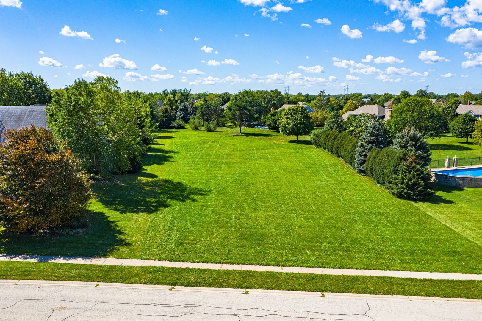 1211 Mink Trail Cary, IL 60013 - Photo 2 of 7 a view of a big yard with large trees