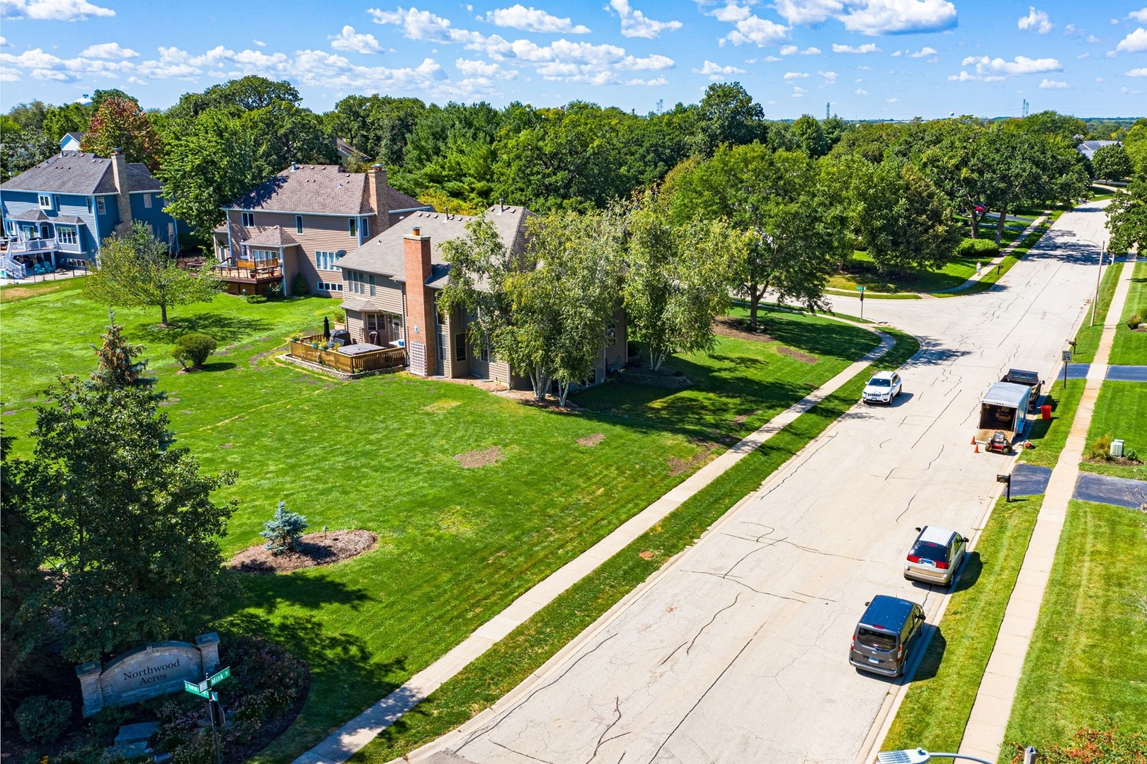 1211 Mink Trail Cary, IL 60013 - Photo 5 of 7 a view of a garden with a building in the background