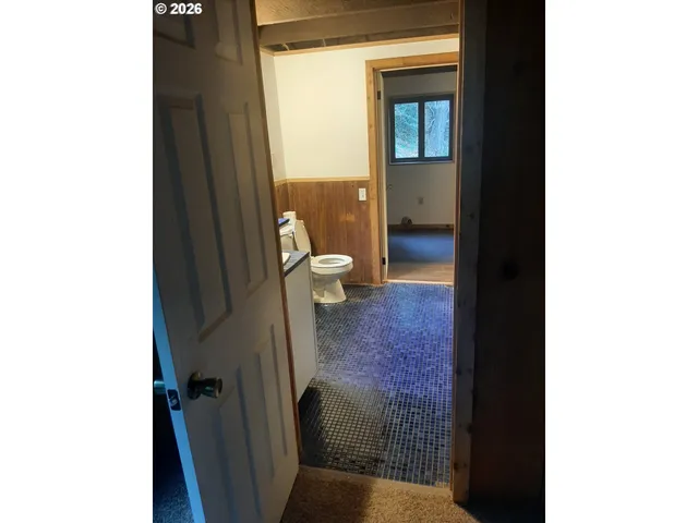 an empty room with wooden floor and sliding door