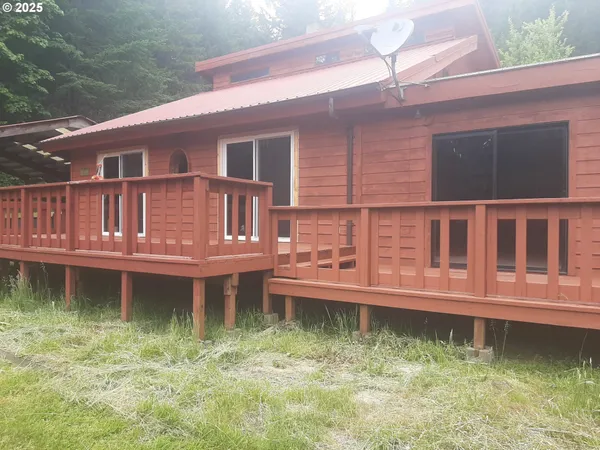 a backyard of a house with a tub and deck