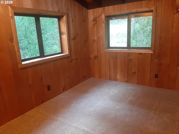 a view of a livingroom with wooden floor and a window