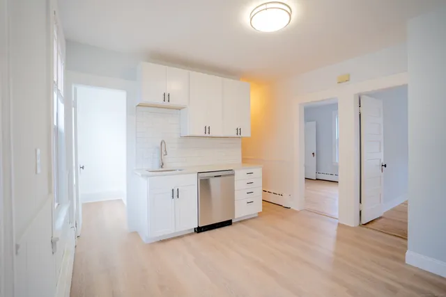 a kitchen with a stove top oven sink and cabinets