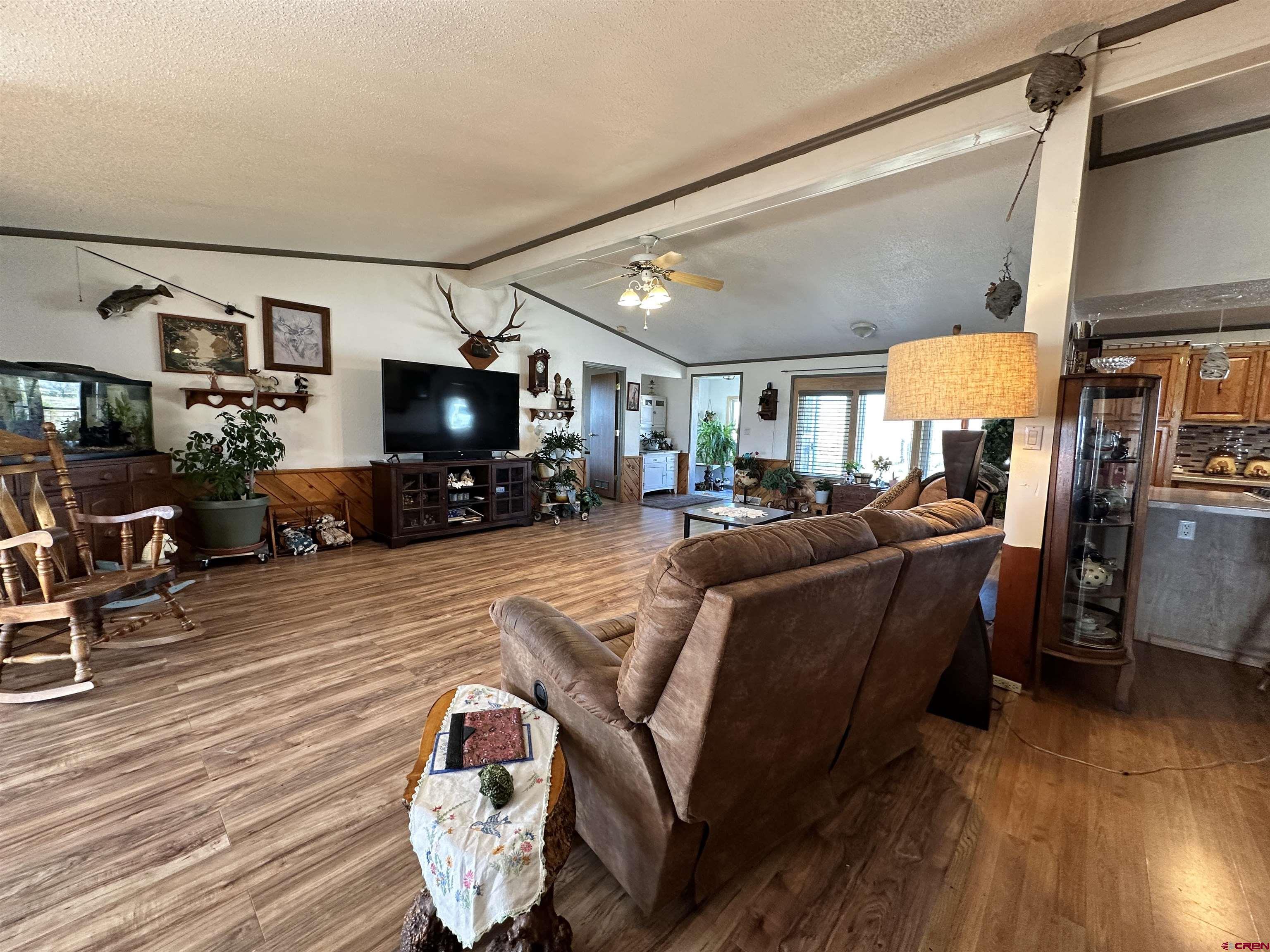 12880 2900th Road Hotchkiss, CO 81419 - Photo 6 of 22 a living room with furniture and a flat screen tv