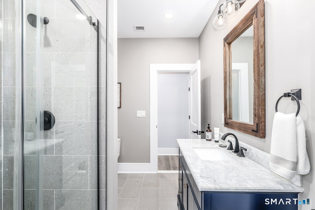 2 Pond View Lane Sherman, CT 06784 - Photo 34 of 40 a bathroom with a granite countertop sink and a mirror