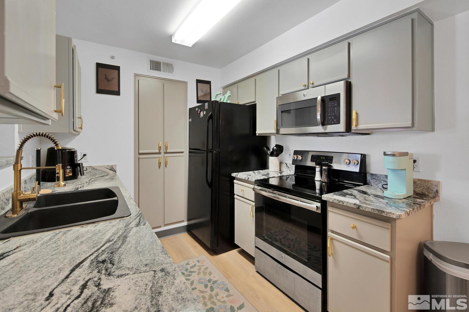 6850 Sharlands Avenue, Unit N2081 Reno, NV 89523 - Photo 11 of 27 a kitchen with stainless steel appliances granite countertop a refrigerator stove and sink