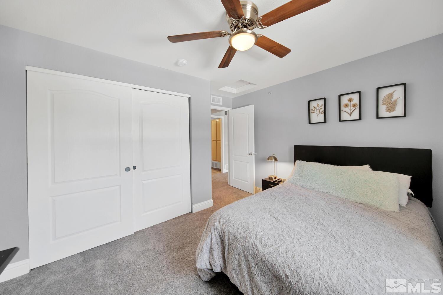 6850 Sharlands Avenue, Unit N2081 Reno, NV 89523 - Photo 17 of 27 a bedroom with a large bed and a ceiling fan