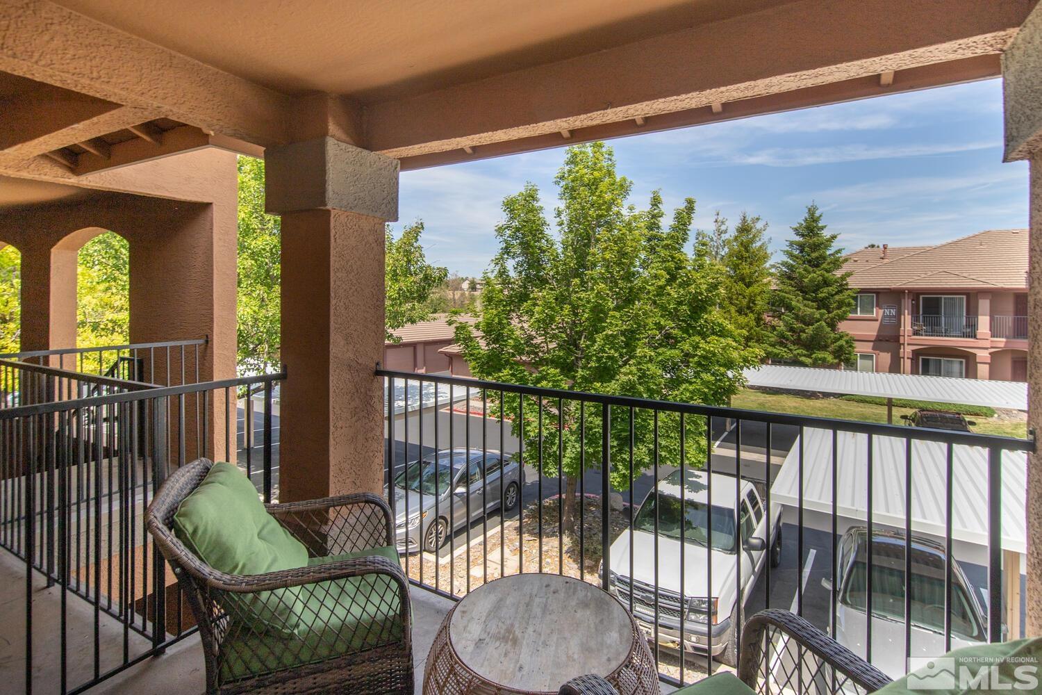 6850 Sharlands Avenue, Unit N2081 Reno, NV 89523 - Photo 21 of 27 a view of a balcony with chair and wooden floor
