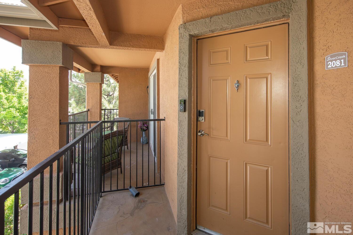 6850 Sharlands Avenue, Unit N2081 Reno, NV 89523 - Photo 3 of 27 a view of a hallway with wooden floor and stairs