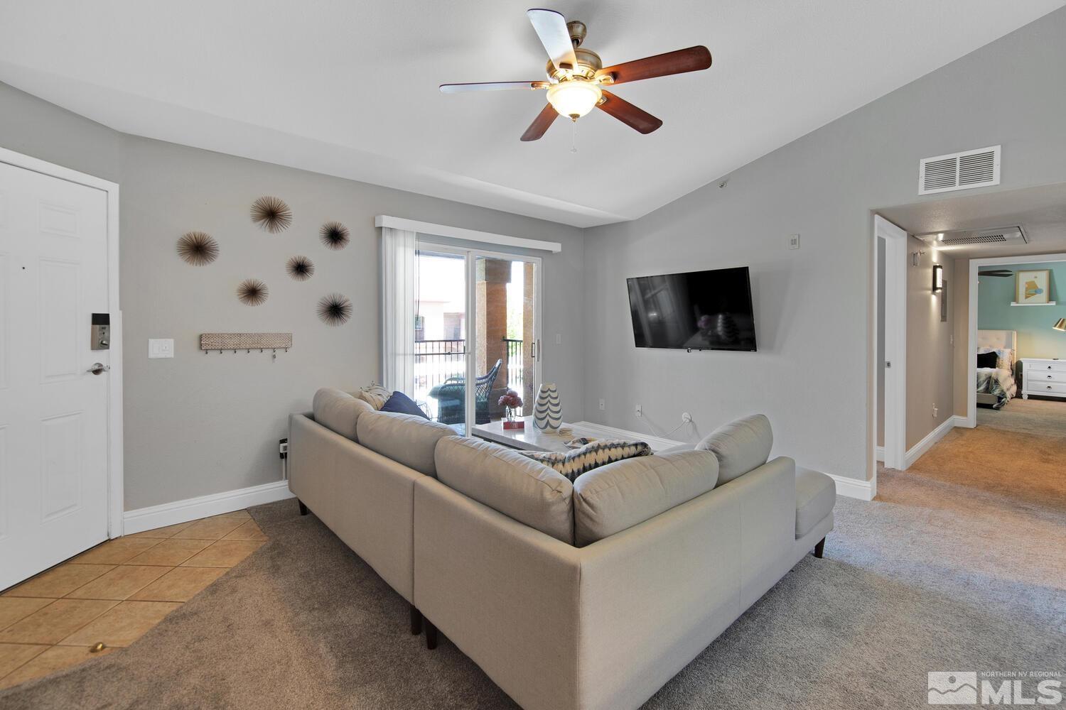 6850 Sharlands Avenue, Unit N2081 Reno, NV 89523 - Photo 4 of 27 a living room with furniture and a flat screen tv