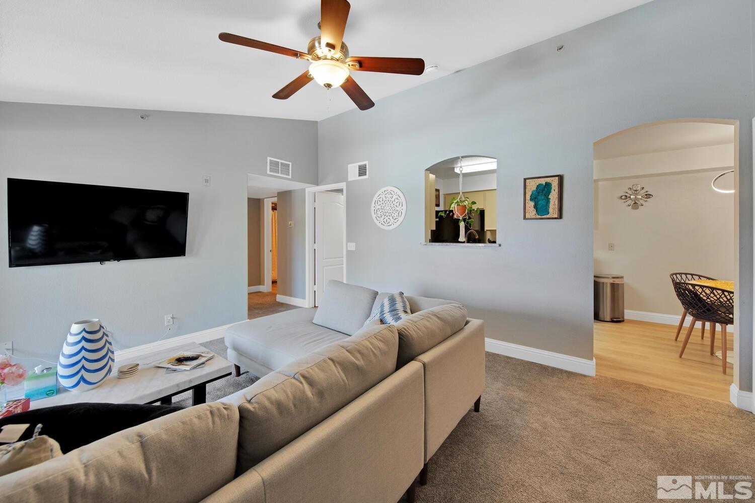 6850 Sharlands Avenue, Unit N2081 Reno, NV 89523 - Photo 7 of 27 a living room with furniture and a flat screen tv