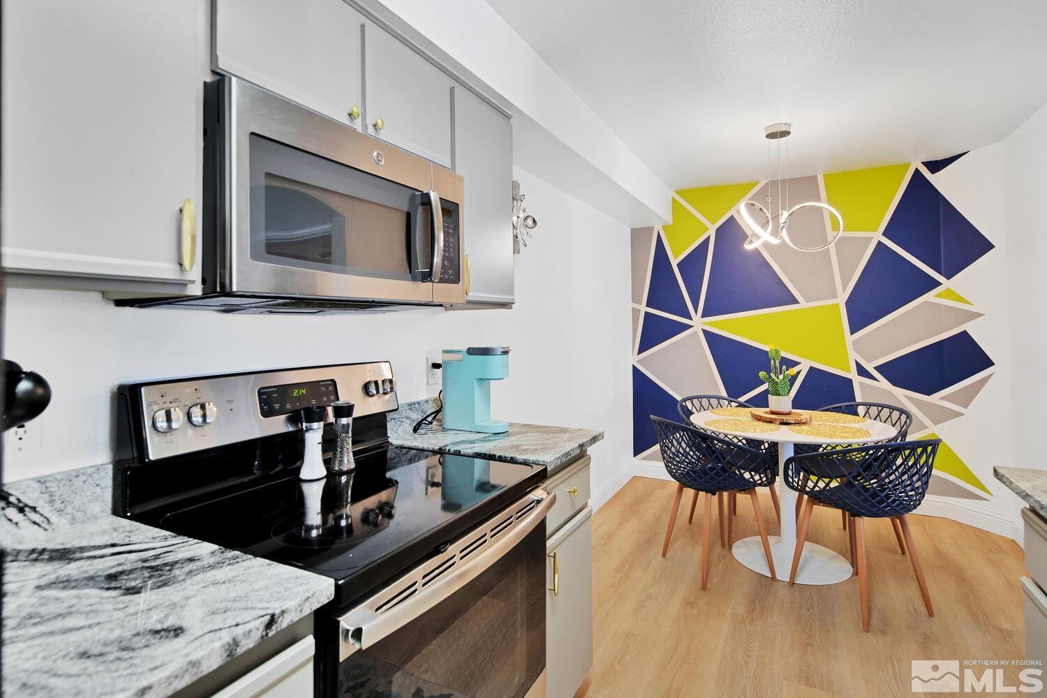 6850 Sharlands Avenue, Unit N2081 Reno, NV 89523 - Photo 9 of 27 a kitchen with a stove and a microwave