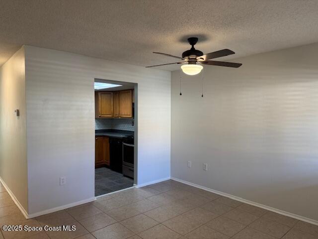 4721 Sisson Road Titusville, FL 32780 - Photo 3 of 29 a view of an empty room with a ceiling fan and kitchen view