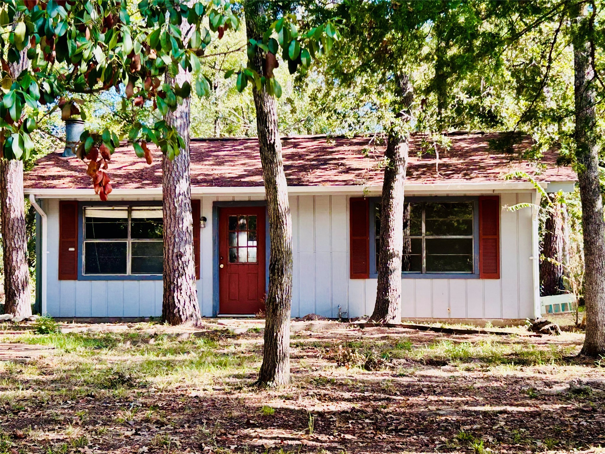 front view of a house with a tree