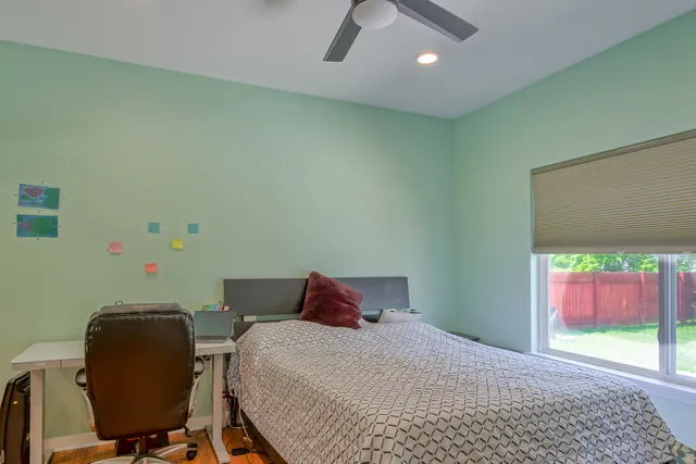 a bedroom with a bed and a chair