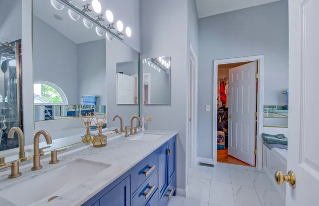 a bathroom with a sink double vanity and a mirror