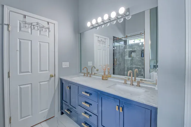 a bathroom with a double vanity sink and a mirror