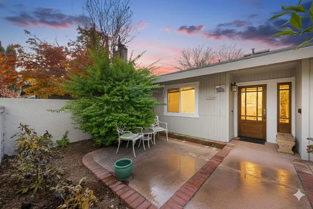 a backyard of a house with table and chairs