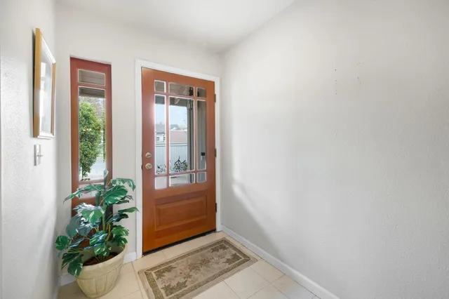 a living room with furniture potted plant and a window