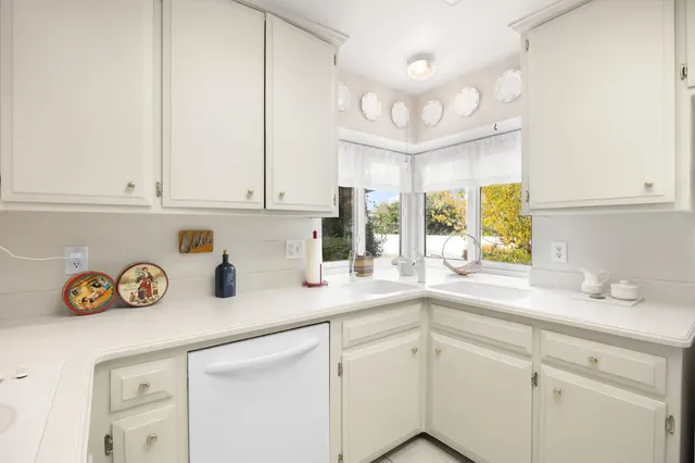 a kitchen with a large window and a sink