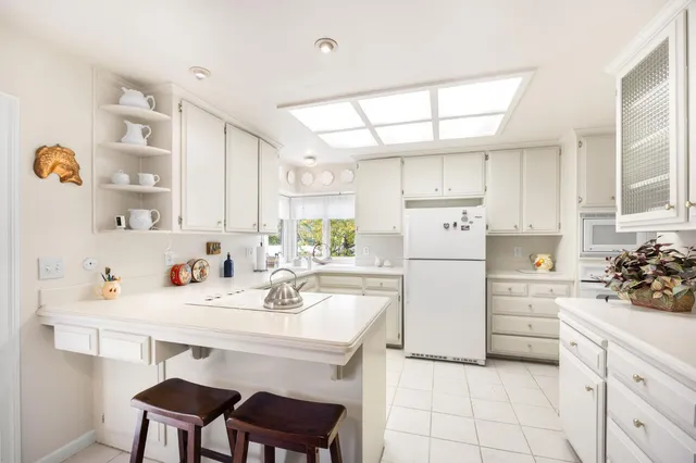 a kitchen with a sink cabinets and window