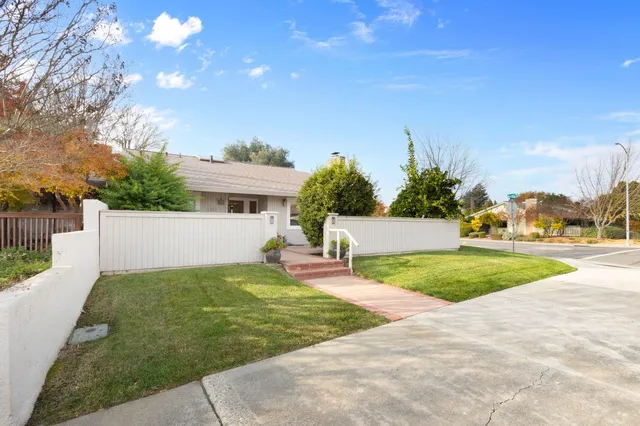 a view of a house with backyard and a tree