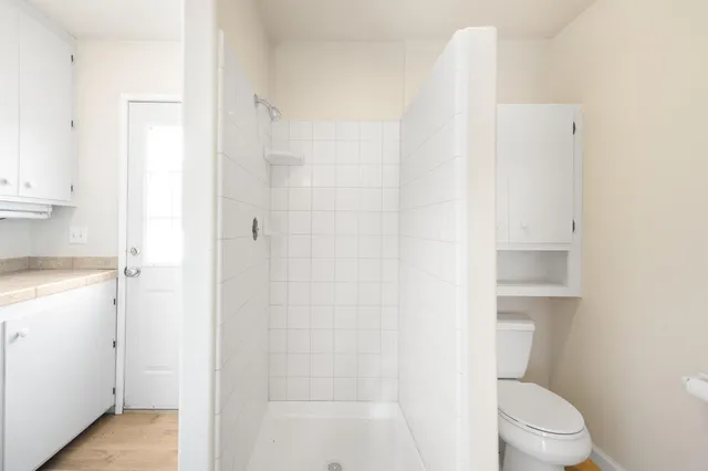 a view of a patio with table and chairs and potted plants with wooden fence