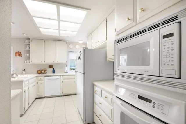 a view of a patio with table and chairs and potted plants