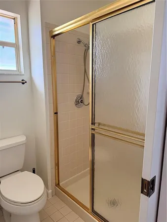 a bathroom with a shower and a toilet